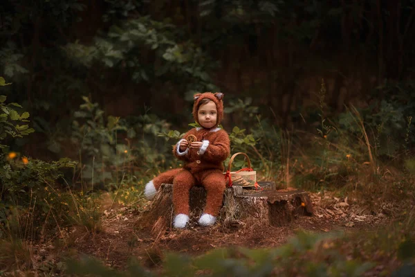 a child in the form of a fox walks in the woods