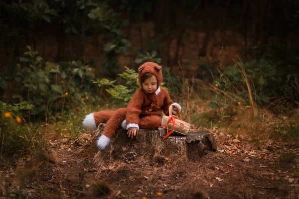 a child in the form of a fox walks in the woods