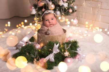 newborn baby on the background of Christmas, Christmas trees, garlands