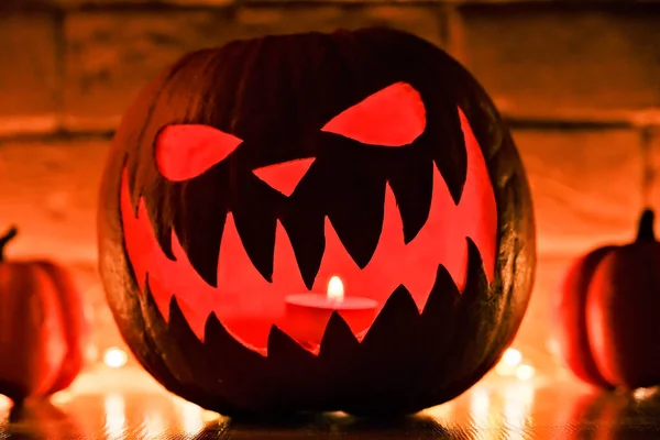 Halloween\'s holiday attributes. Halloween. carved pumpkin. candles . smoke . dark scene. pumpkin head silhouettes.