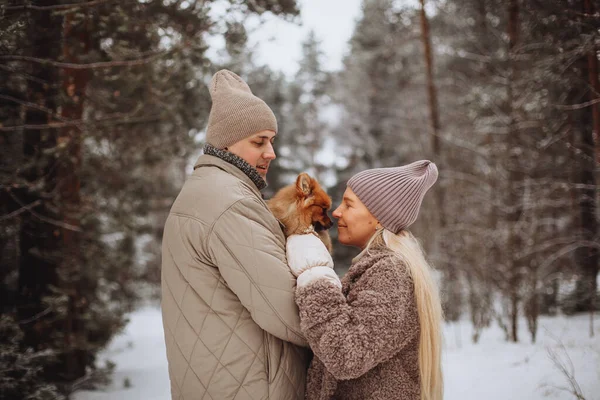 People, season, love and leisure concept - happy couple hugging and laughing outdoors in winter. Couple embracing in snowy winter park.Winter wedding of stylish beautiful young couple bride and groom — Stockfoto