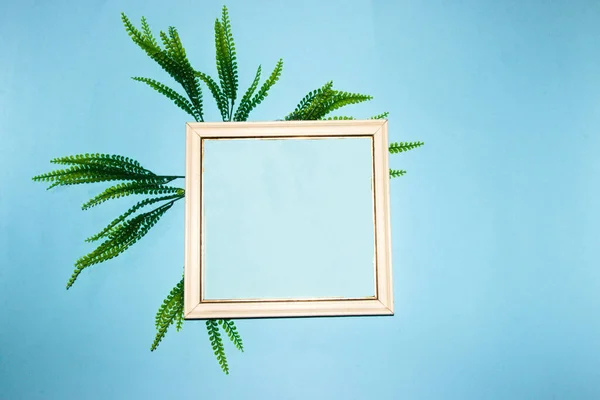 old retro frame with pastel blue copy space around it pastel blue wallpaper with jungle leaves, modern summer design