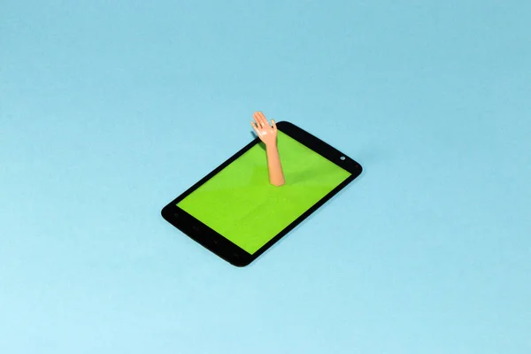 phone with green display from which hand is waving, creative art modern design on blue background