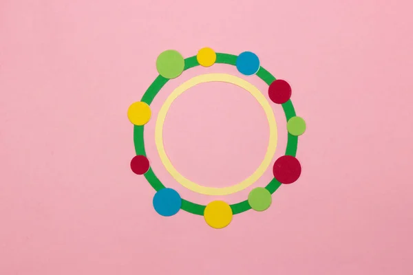 green circle covered with colorful dots in which yellow circle as copy space, creative art design on pink background, dot day