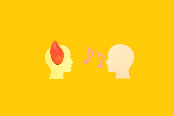 creative minimal concept man listens to another man, one head has an ear, the other head talks, yellow background