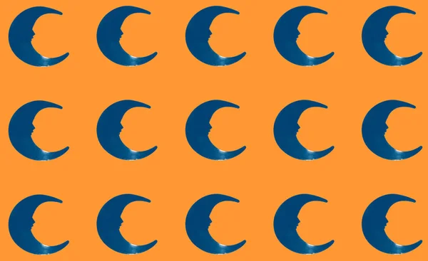 blue crescent moon copied on orange background, creative pattern, complementary colors, art design