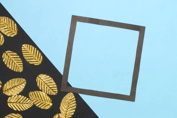 black and blue background, on the black part golden leaves on the blue black frame as copy space