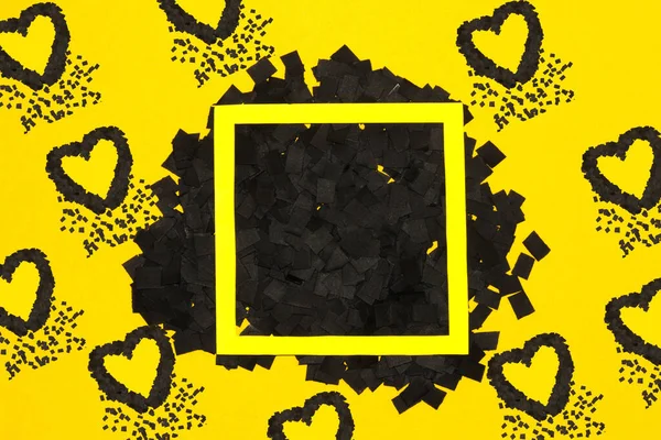 yellow frame on black part of yellow background, black hearts around the frame, creative art love design