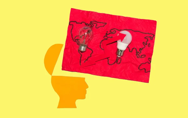 open paper head with world map and two light bulbs with red arrow, global energy crisis