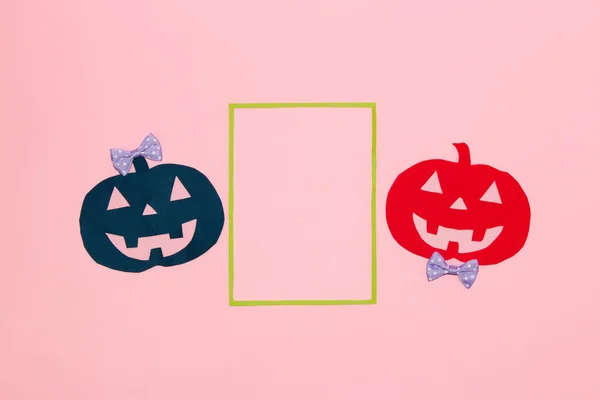 two paper party pumpkins next to the frame as copy space, flat lay, paper craft, creative halloween concept