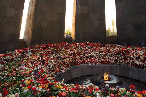 Flowers near the "eternal fire" on the territory of The Armenian Genocide Memorial complex in Yerevan. Armenia