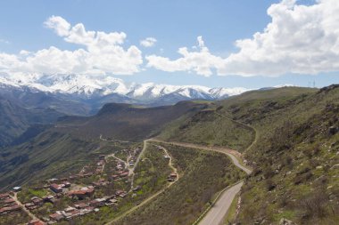 Ermeni köyü Halidzor 'un karlı dağ tepelerinin manzarası teleferiğin yanında 
