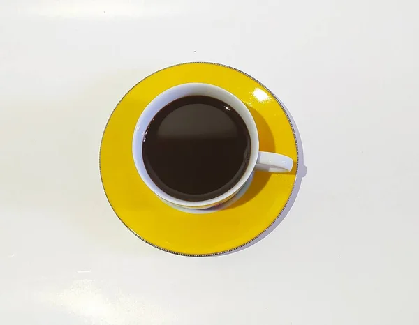 Black Coffe Yellow Glass White Background — стоковое фото