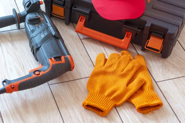 Top view of Working tools.rotary hammer, tool box, work cap, gloves. Worker gear concept