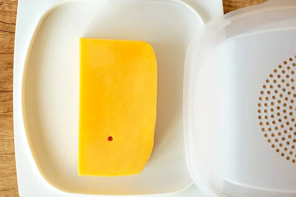 cheese pan.Cheese storage item. Concept of storing cheese in the refrigerator.