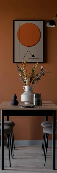 Vertical panorama of simple table in eclectic dining room with orange wall and art