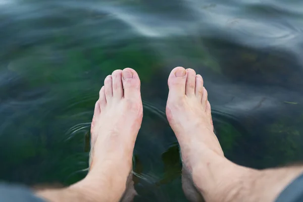 feet of a woman in a swimming pool