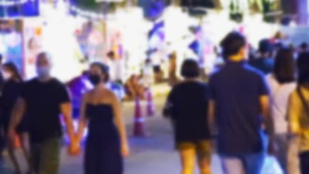 Pattaya, Thailandia - 29 novembre 2021: persone sfocate che camminano di notte di fronte a Pattaya Beach Road dopo che il governo ha annullato l'isolamento della città a causa del virus Covid 19. — Video Stock