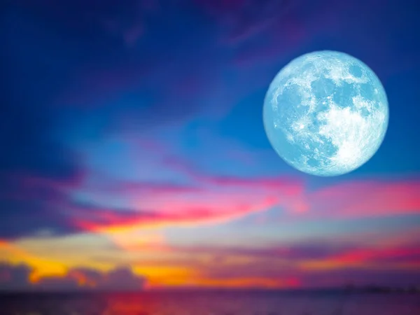 Full blue moon and blur sunset sky colorful cloud on the ocean