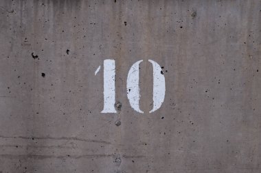 10, round number printed in white on a wall, horizontal picture