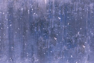 bluish-gray colored laminate with cracks and small holes. Full view