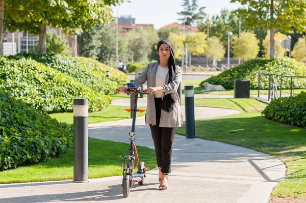 Güneşli Bir Günde Parkta Elektrikli Scooterıyla Kameraya Bakan Müslüman Bir — Stok fotoğraf