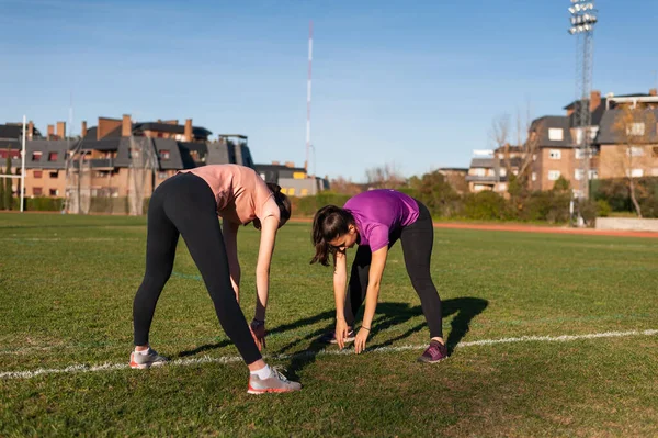 Two Young Women Doing Stretching Grass Running Track Playing Sports — Foto de Stock