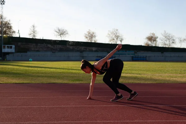 Young Sportsman Running Track Doing Stretching Exercises — Fotografia de Stock