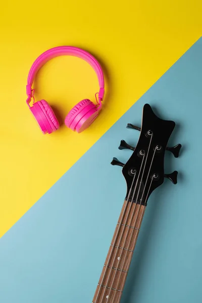 Headstock Guitar Headphones Placed Each One Side Diagonal Division Background — Stock fotografie