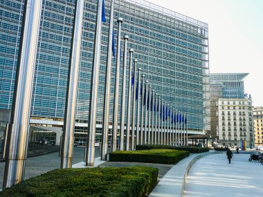 Flagpoles and the Berlaymont building in Brussels 