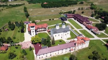 Geniş bir çayırı olan büyük bir kilise arazisi ve güneşli bir yaz gününde taş çitleri ve yüksek duvarları olan eski kiliseler.