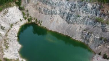 Koyu yeşil göl 10 kozalaklı ağaçlarla çevrili.