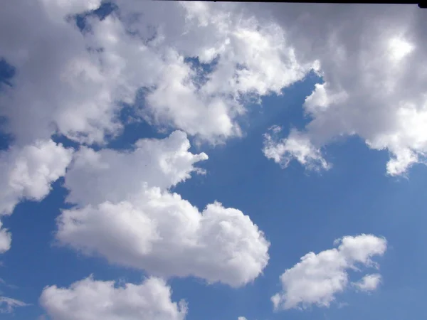 The heavenly landscape is filled with snow-white clouds of amazing shapes at the discretion of one's own imagination.