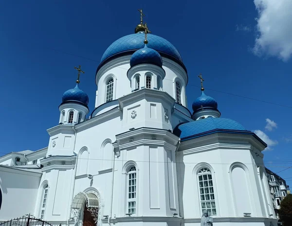 A worshiper's reverent view from below of the beauty and majesty of the Orthodox cathedral against the background of the morning blue sky.