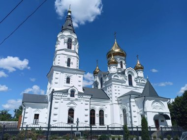 A panorama of the beauty and grandeur of the Orthodox Cathedral in the rays of the morning sun against the background of a blue, barely cloudy sky.