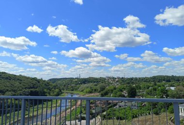 An unsurpassed view from the bridge of the half-dried Teterev River, which bypasses the mountain forest on one side, and the recreation park on the other.