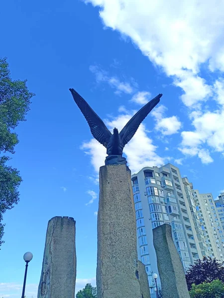 A view from below of a sculptural composition of a steppe eagle that has spread its wings and is ready to catch up with the expected prey.