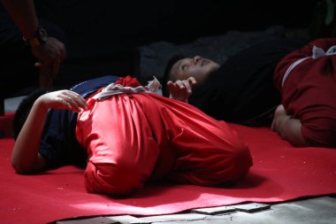 Bangkok, Khon 'u öğrenmek için bir çocuk kırmızı halıda vücudunu geliştiriyor. Khon, Tayland 'da bir dans drama türüdür..