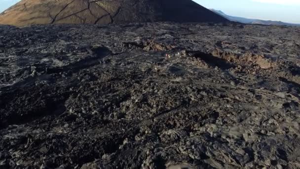 A huge frozen lava field on the background of a volcano — Stockvideo