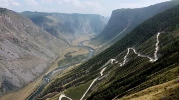 A larger canyon with a winding road — стоковое видео