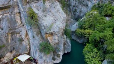 flying over turquoise water in a canyon