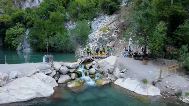 Tourists put on life jackets and helmets for rafting down the canyon Turkey — Stock Video