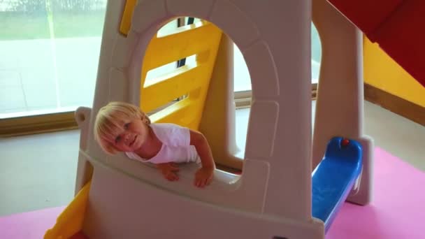Happy baby plays playroom and smiles at parents — Video Stock