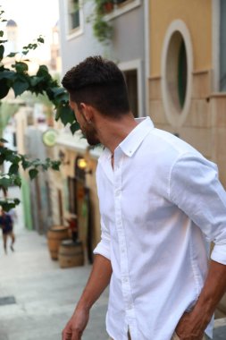 Alicante şehrinde model kılığında sakallı yakışıklı, esmer bir adam.