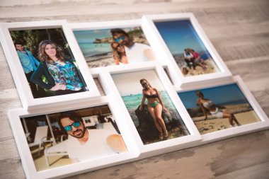 Yazın Mallorca sahillerinde birbirini seven bir çiftin beyaz çerçeveli fotoğrafları. Gri ahşap bir arka planı var.
