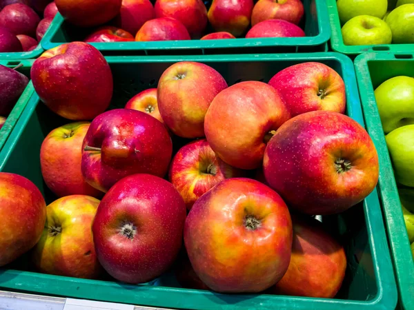 Fresh apples are in a box in the store