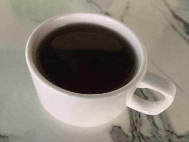 a cup of hot tea on a marble table