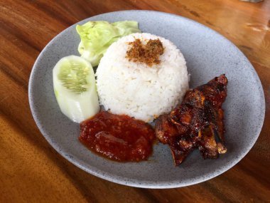 a plate of rice with sweet roasted duck