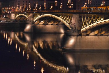 photo of a bridge in Budapest. The bridge reflections in the river