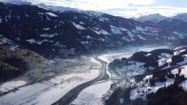 Austrian Alps Cold Mountain Top Snow Mountains Peaks Landscape Drone Aerial Flight drone flyover the mountains and skiing village